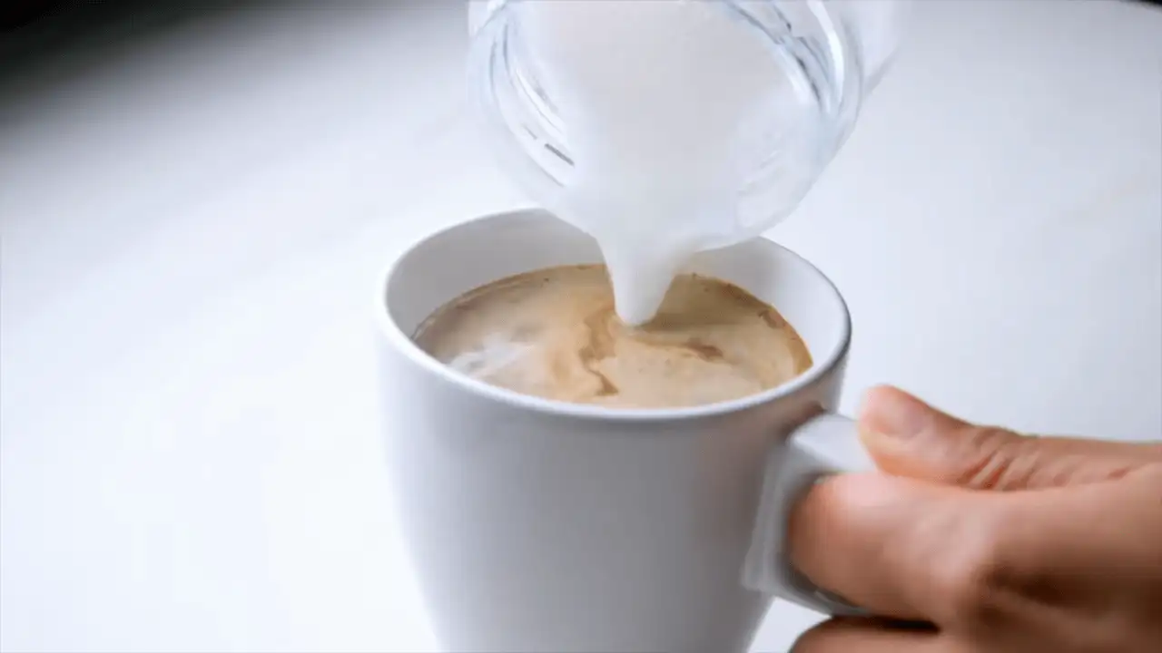 Caffè Mocha on a cup, pouring the milk