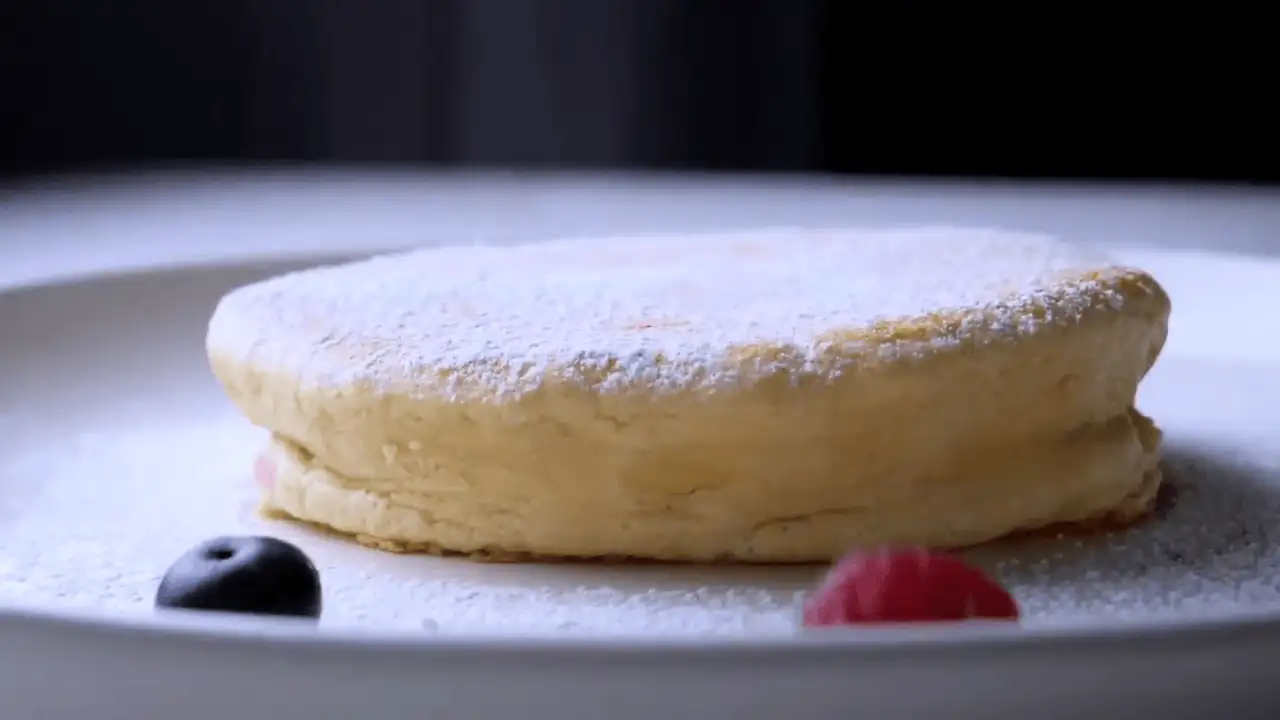 Japanese Souffle Pancakes on a serving plate with some berries