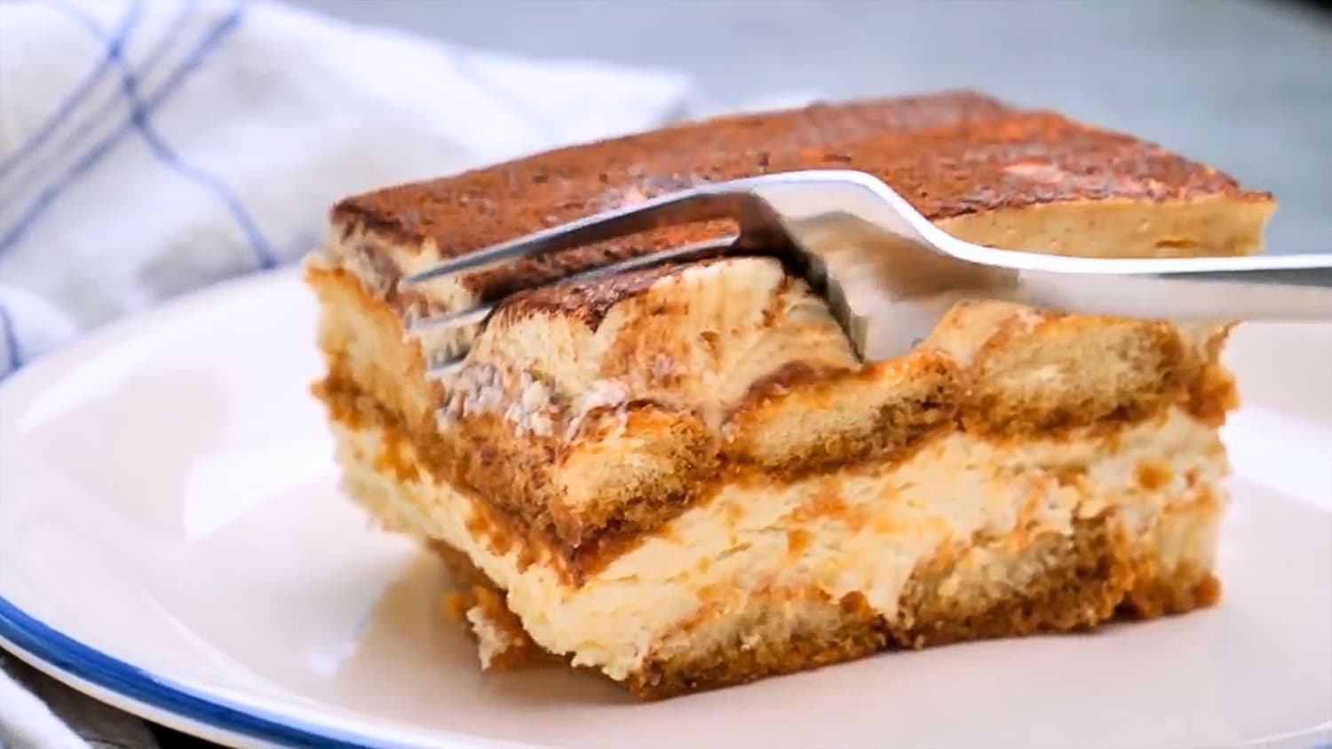 Best Homemade Tiramisu piece on a serving plate with a fork