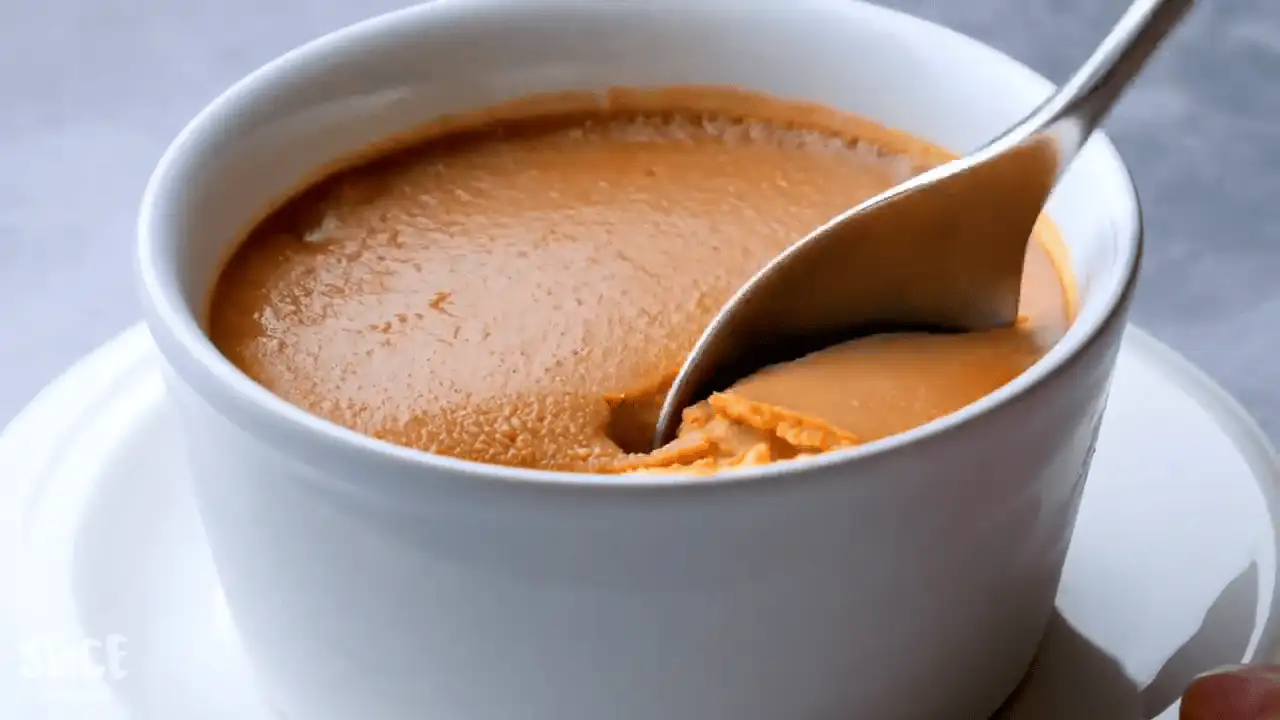 Easy caramel custard recipe in ramekins with a spoon