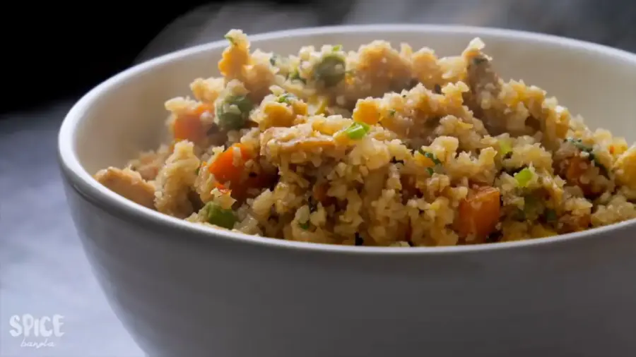 15 Minutes of Cauliflower Fried Rice with chicken is on a serving bowl