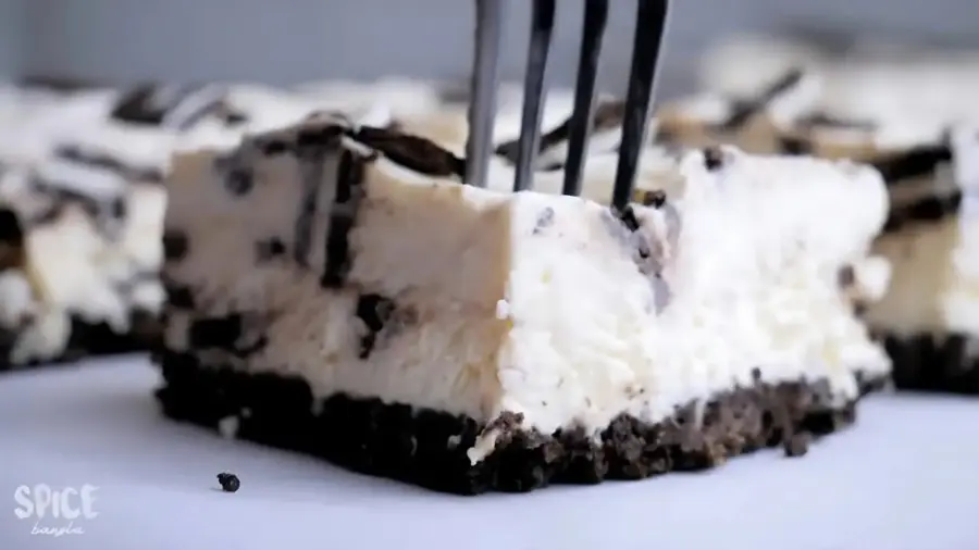 No-Bake Oreo Cheesecake Bars on a serving surface with a knife