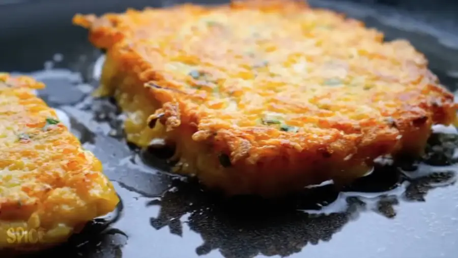 Spicy Hash Browns frying on a fry pan