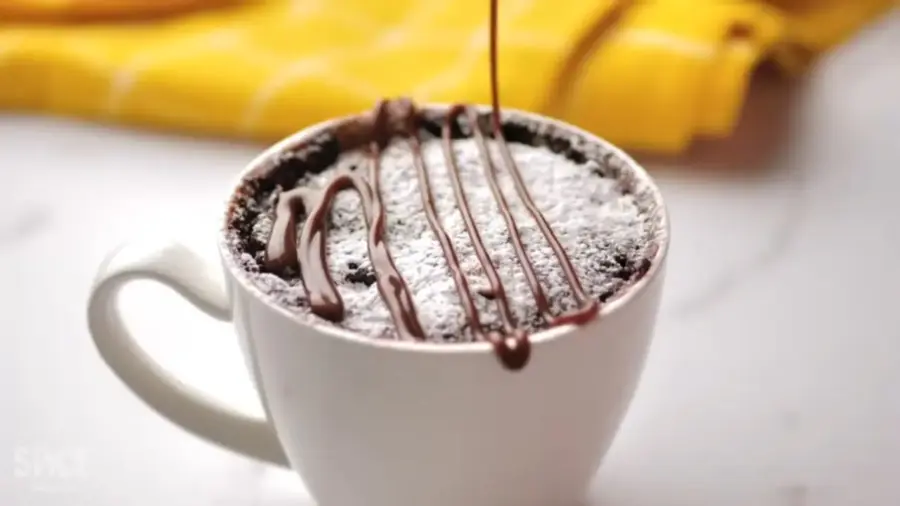 1 Minute Perfect Chocolate Mug Cake topping with chocolate sauce 