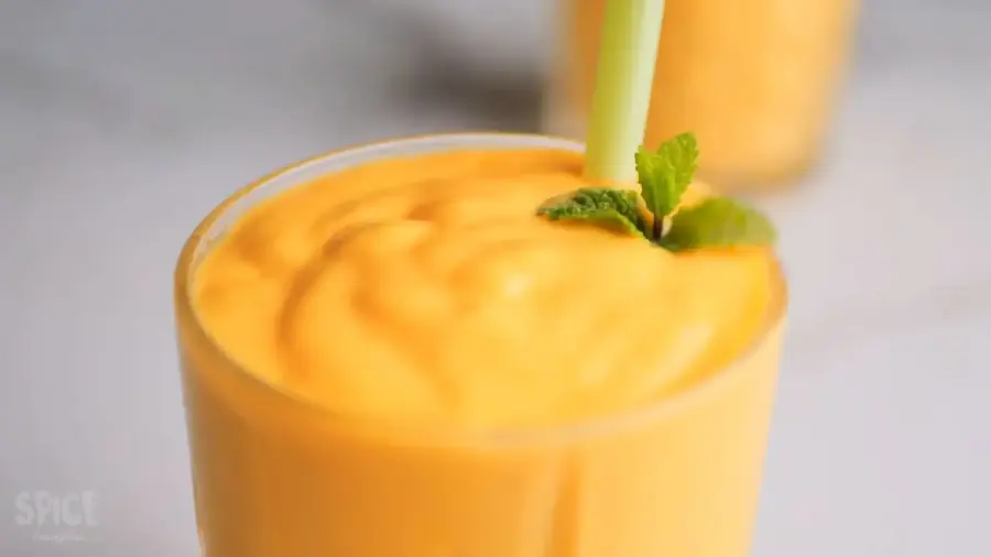 1-Minute Mango Smoothie in a glass with a straw