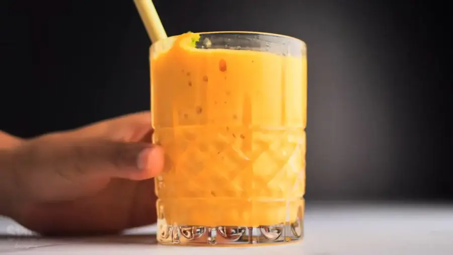 1-Minute Mango Smoothie in a glass with a straw