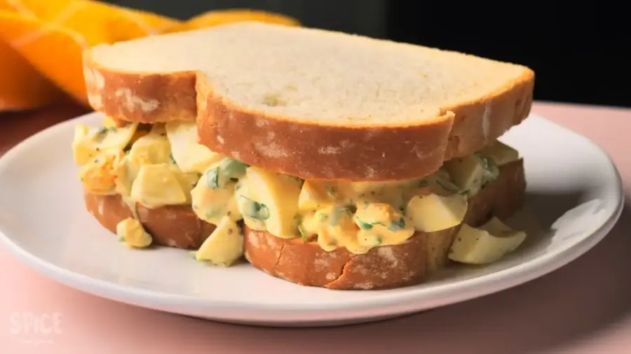 Egg salad sandwich on a serving plate