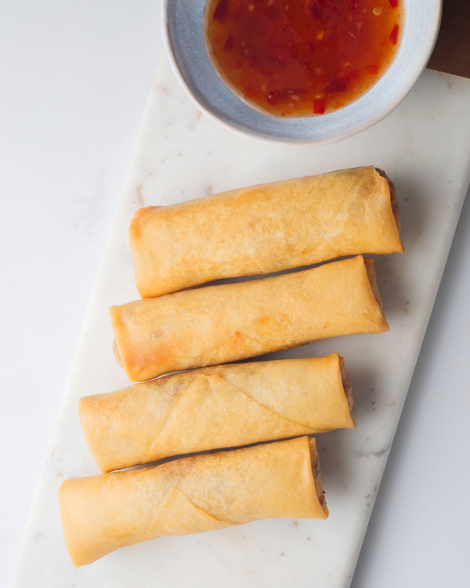 pieces of chicken spring rolls in a serving plate