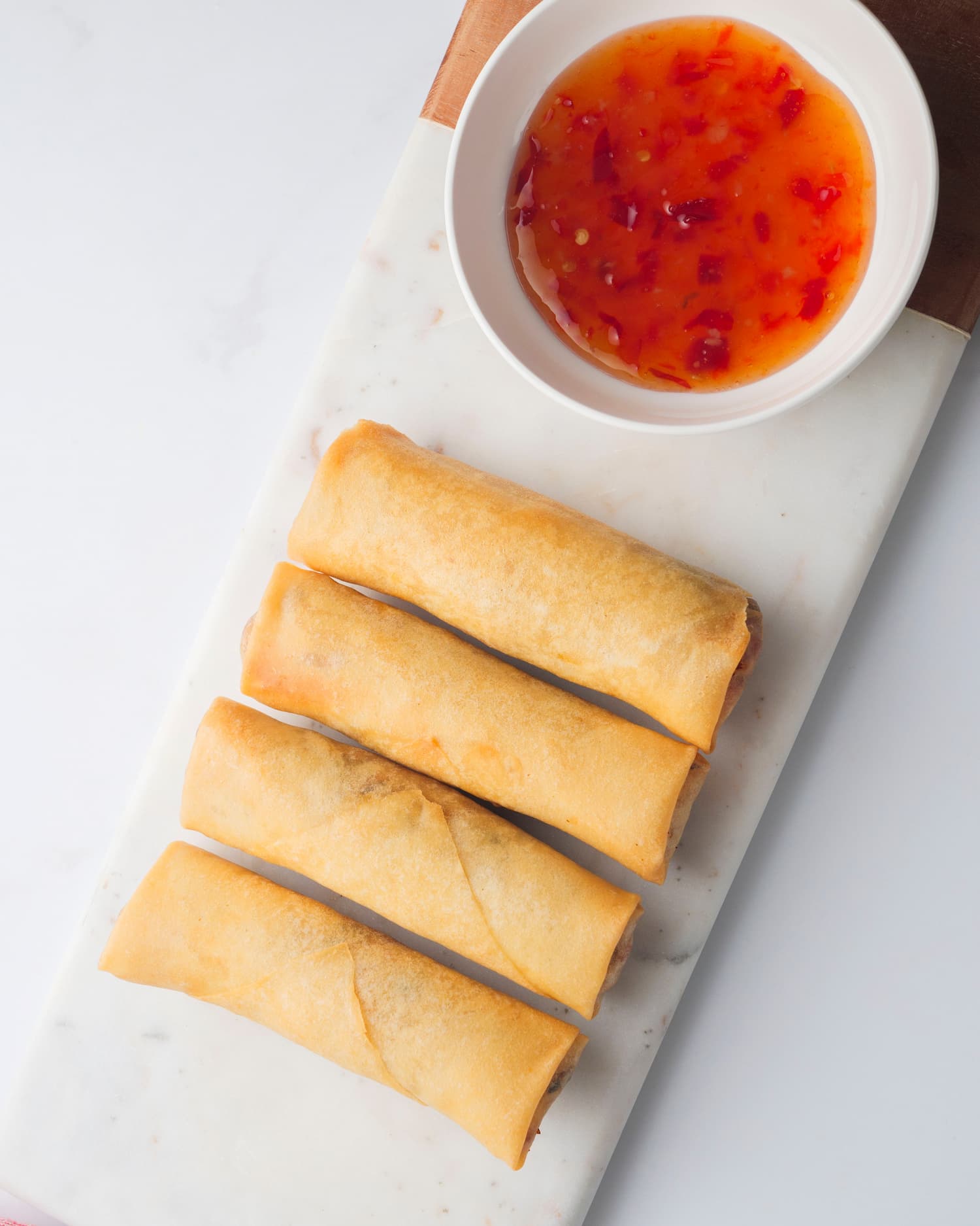 pieces of chicken spring rolls in a serving plate