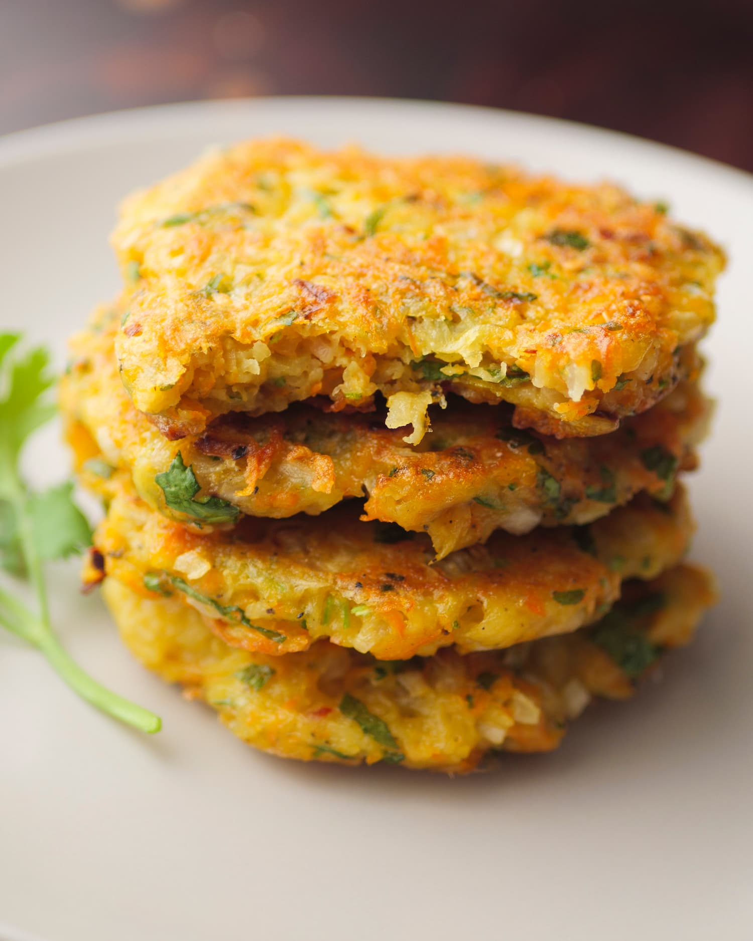 stakes of potato and carrot fritters serve on a plate