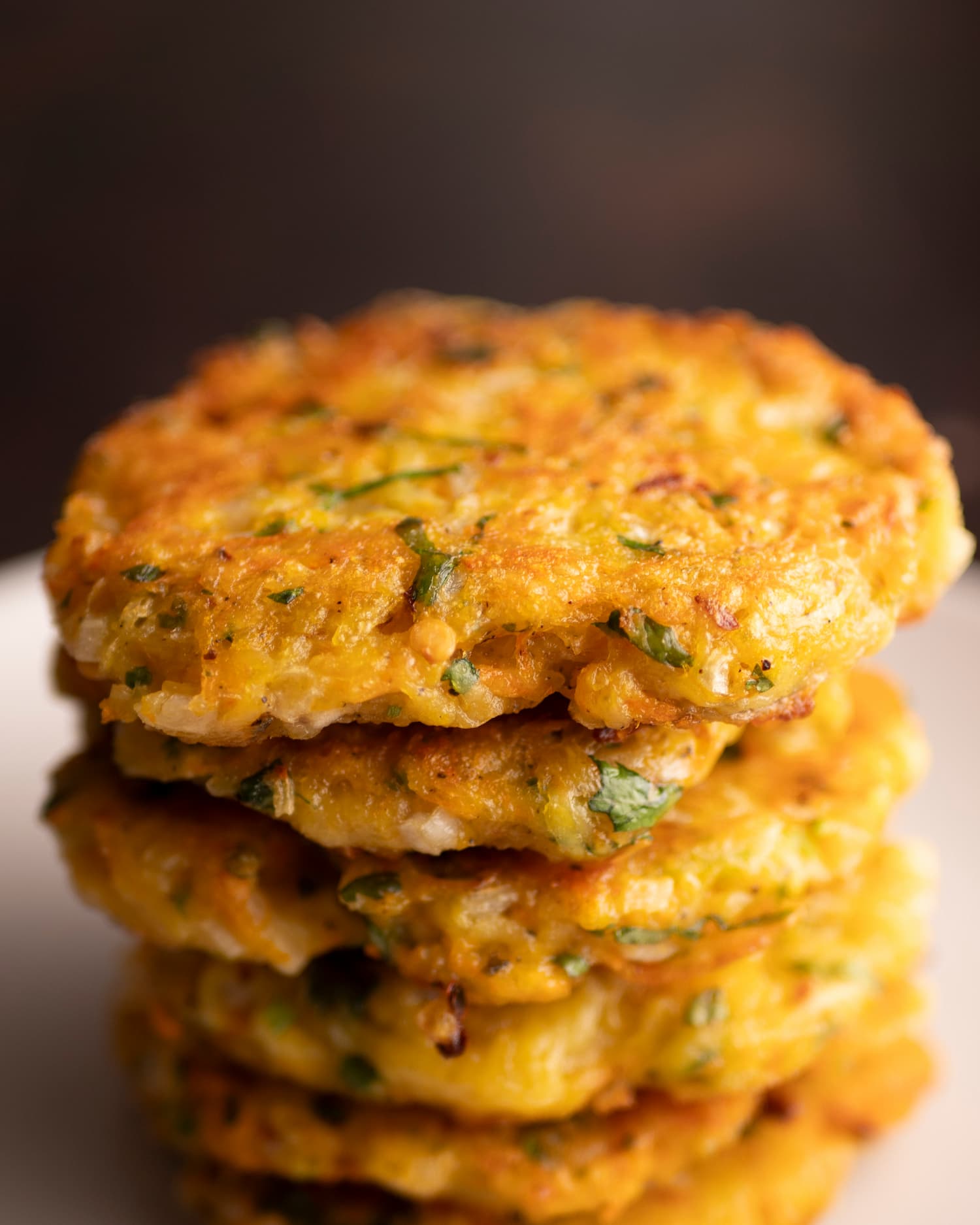 stakes of potato and carrot fritters serve on a plate