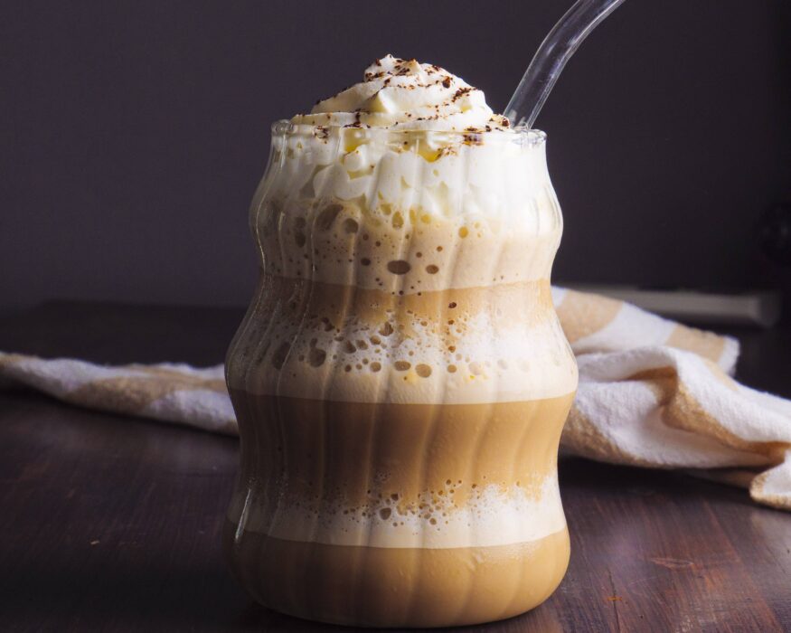 Coffee Frappuccino in a glass with a straw