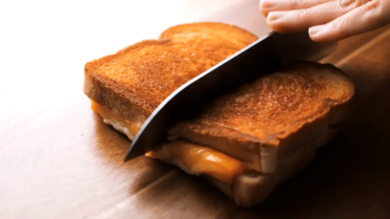 Grilled Cheese Sandwich Recipe sliced in half with a knife