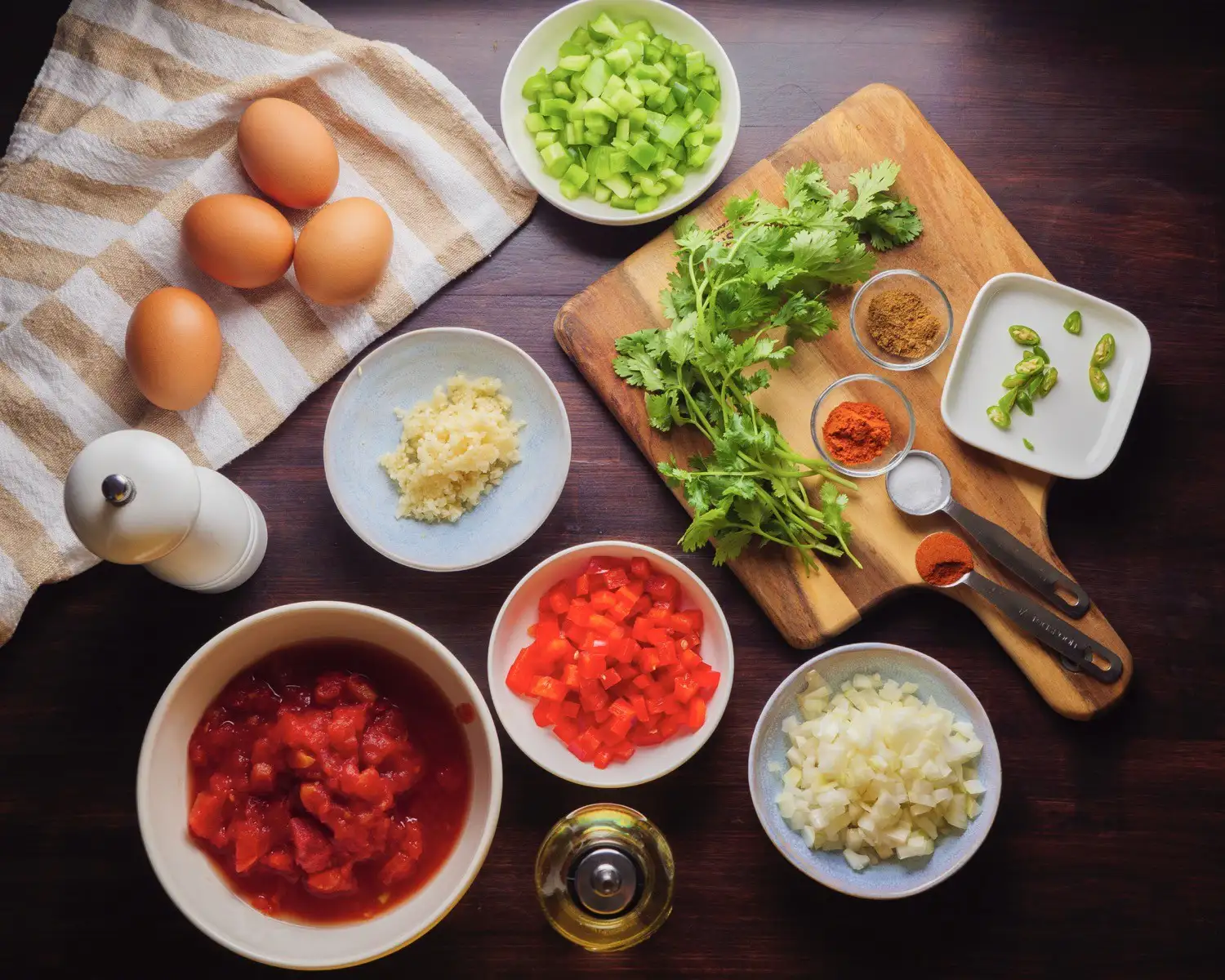 Shakshuka Recipe Ingredient on spoons, board, and bowls