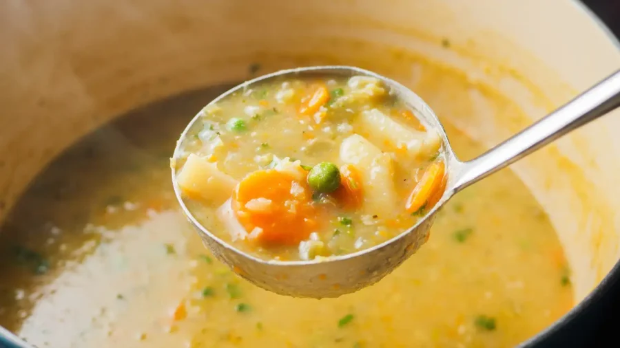 Vegetable Soup Recipe in a Dutch oven with a soup spoon