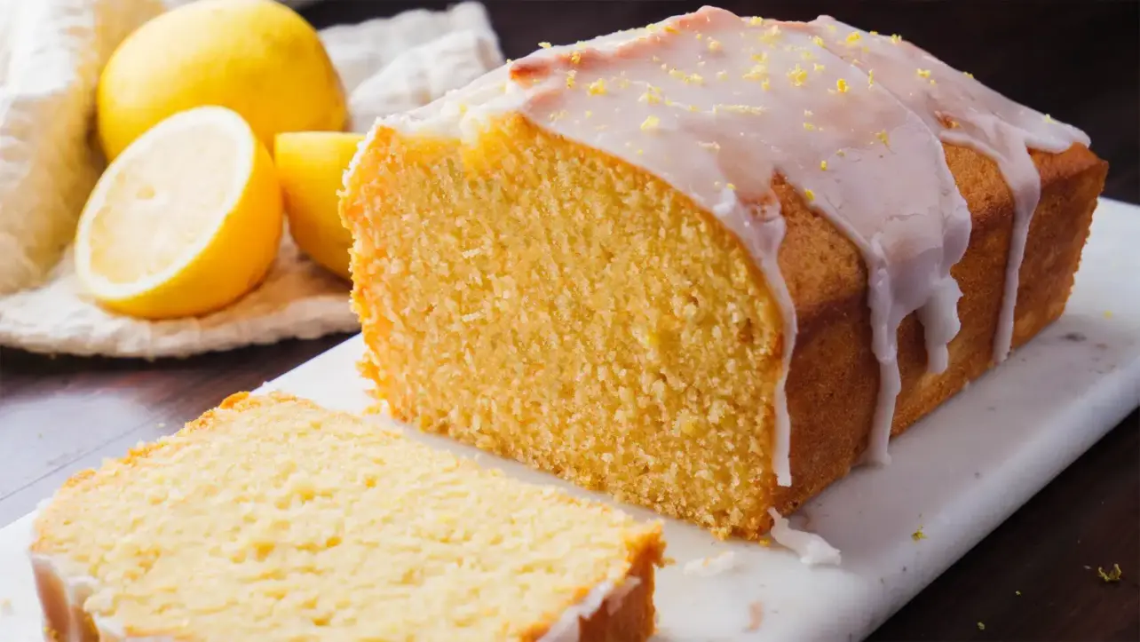 Lemon Loaf Cake with a piece falling on the surface