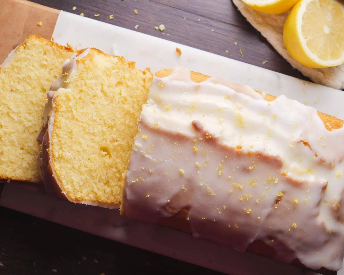 Lemon Loaf Cake with a piece falling on the surface