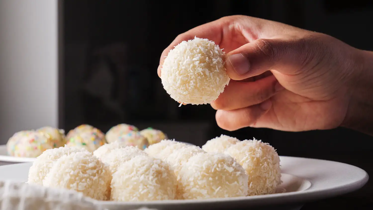 Coconut Balls Recipe on a serving plate Also in hand