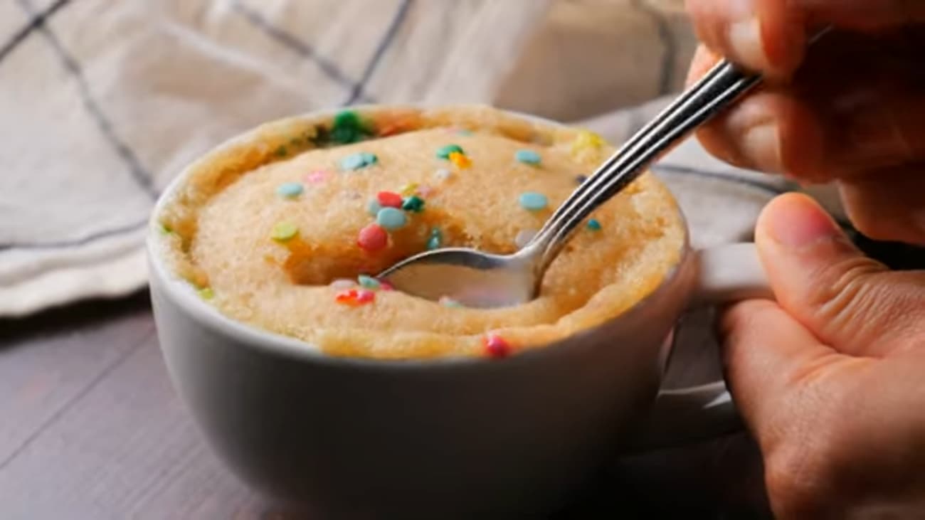 Mug Vanilla Cake in a Mug with a spoon on a surface