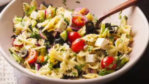 Pasta Salad Recipe in a bowl with a wooden spoon