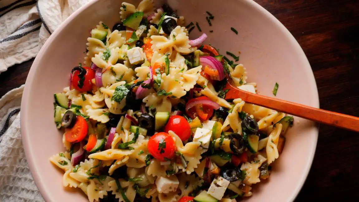 Pasta Salad Recipe in a bowl with a wooden spoon