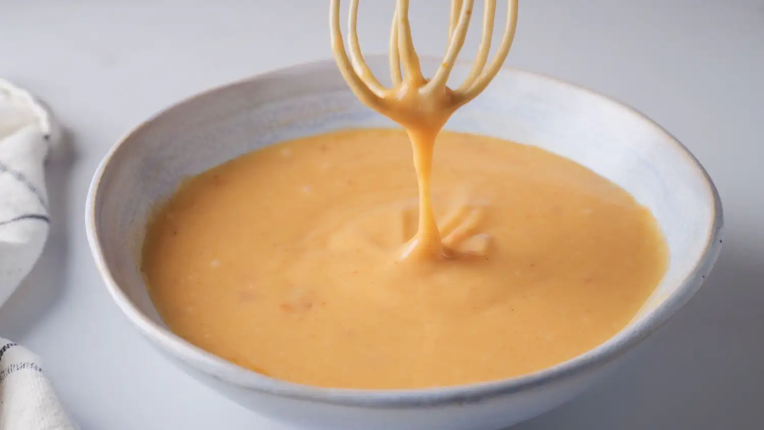 Bang Bang Sauce Recipe (Bonefish Grill Copycat) on a bowl with a whisk