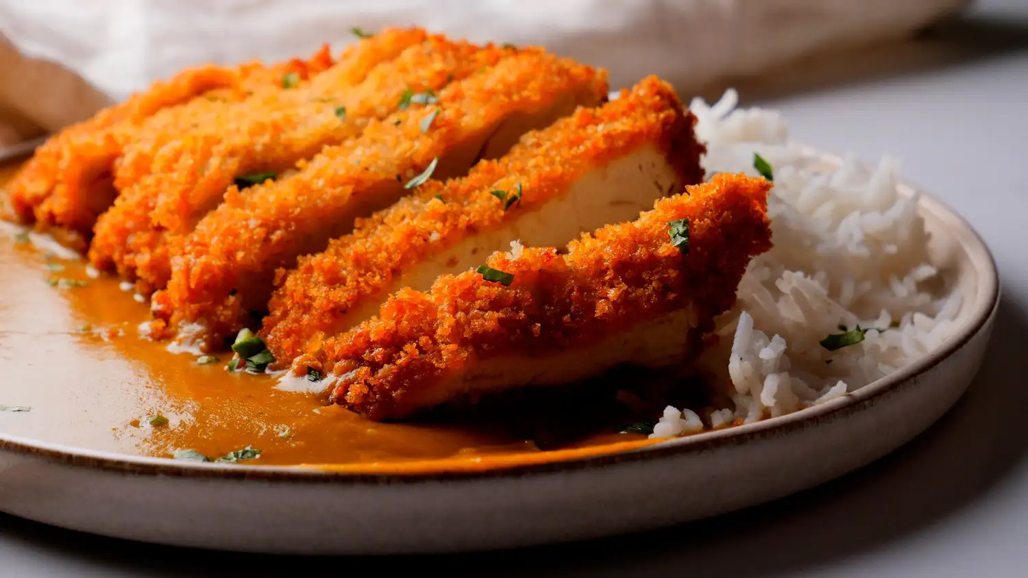 Japanese Chicken Katsu Curry serving with rice on a serving plate