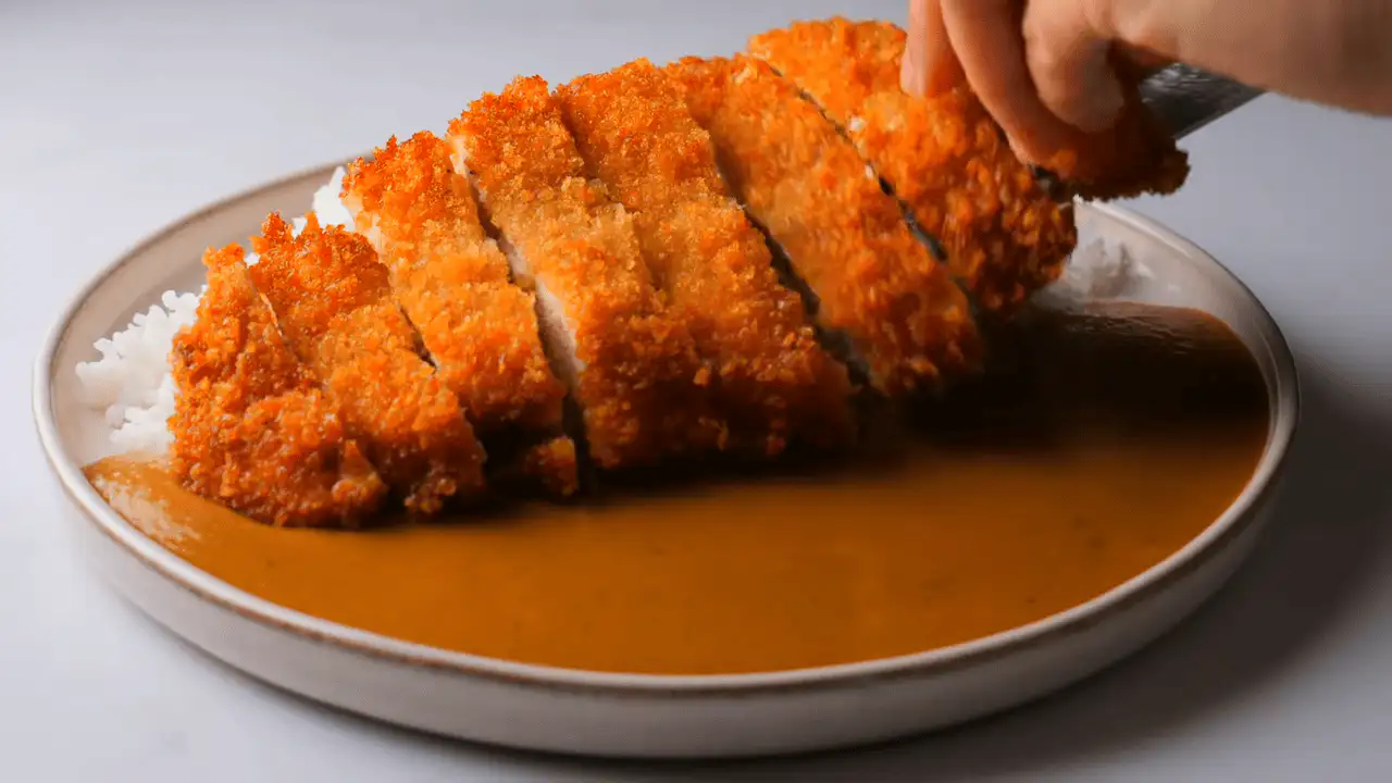 Japanese Chicken Katsu Curry serving with rice on a serving plate