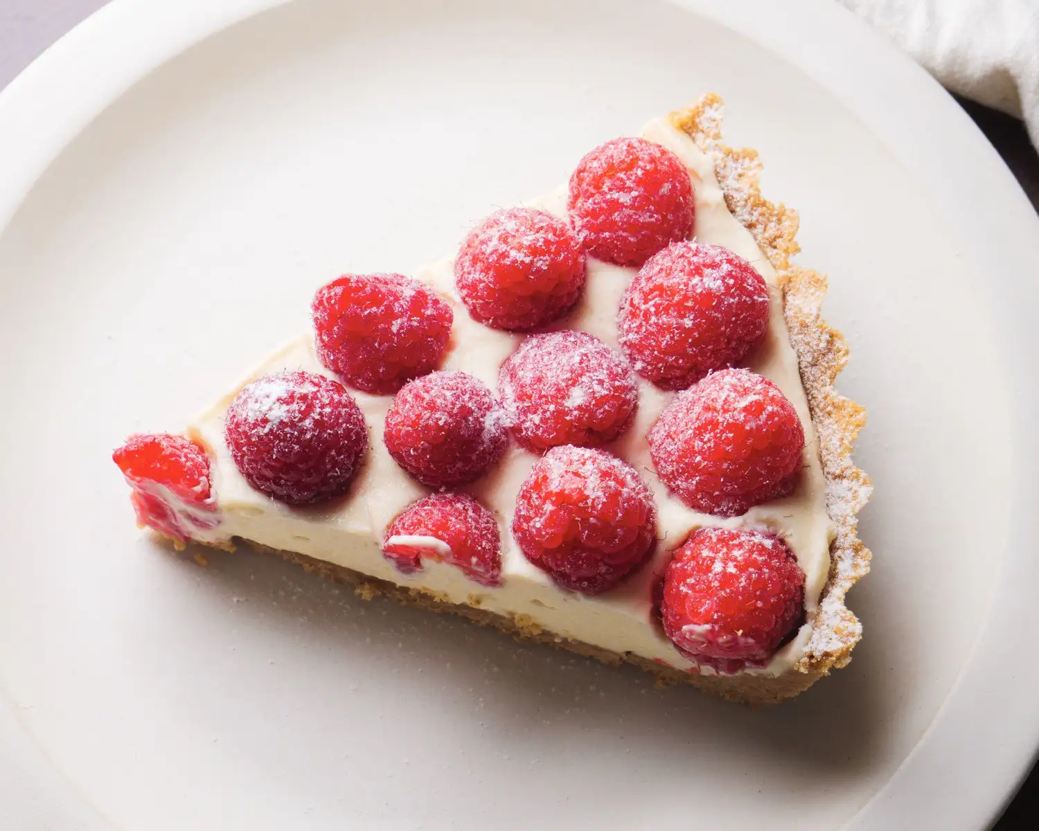 One Piece Of Raspberry Tart On A Serving Plate 