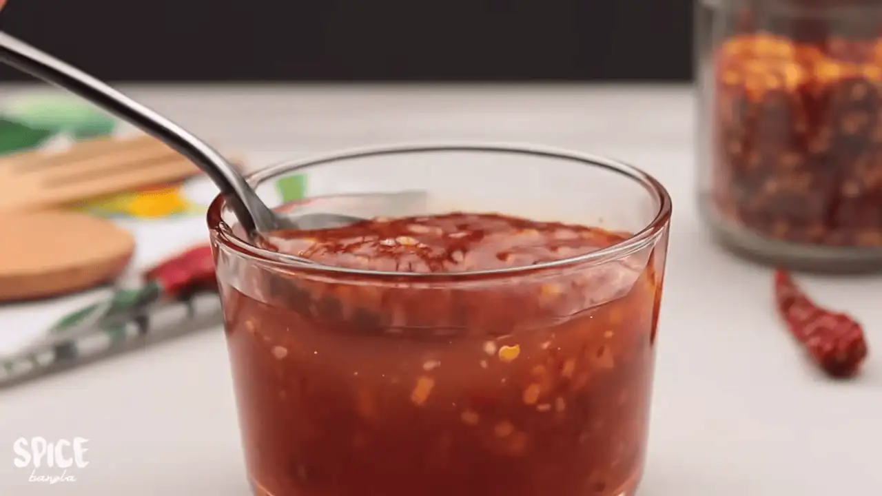 Sweet Chili Sauce Recipe in a jar with a spoon