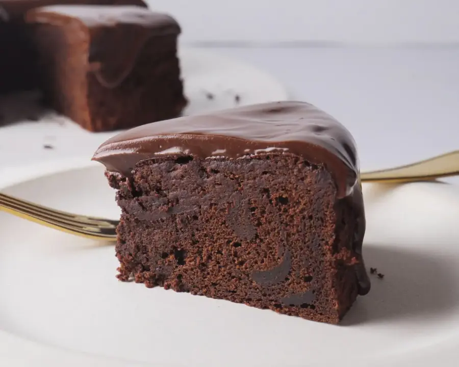 Brownie Cake slice on a serving plate with a fork