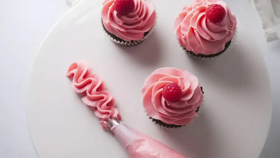 Raspberry Frosting on a chocolate cupcake and cake stand