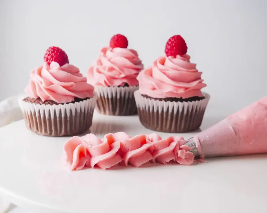 Raspberry Frosting on chocolate cupcakes and cake stands